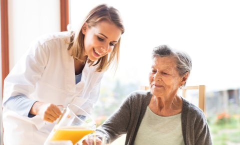 a caregiver woman serving an elderly woman
